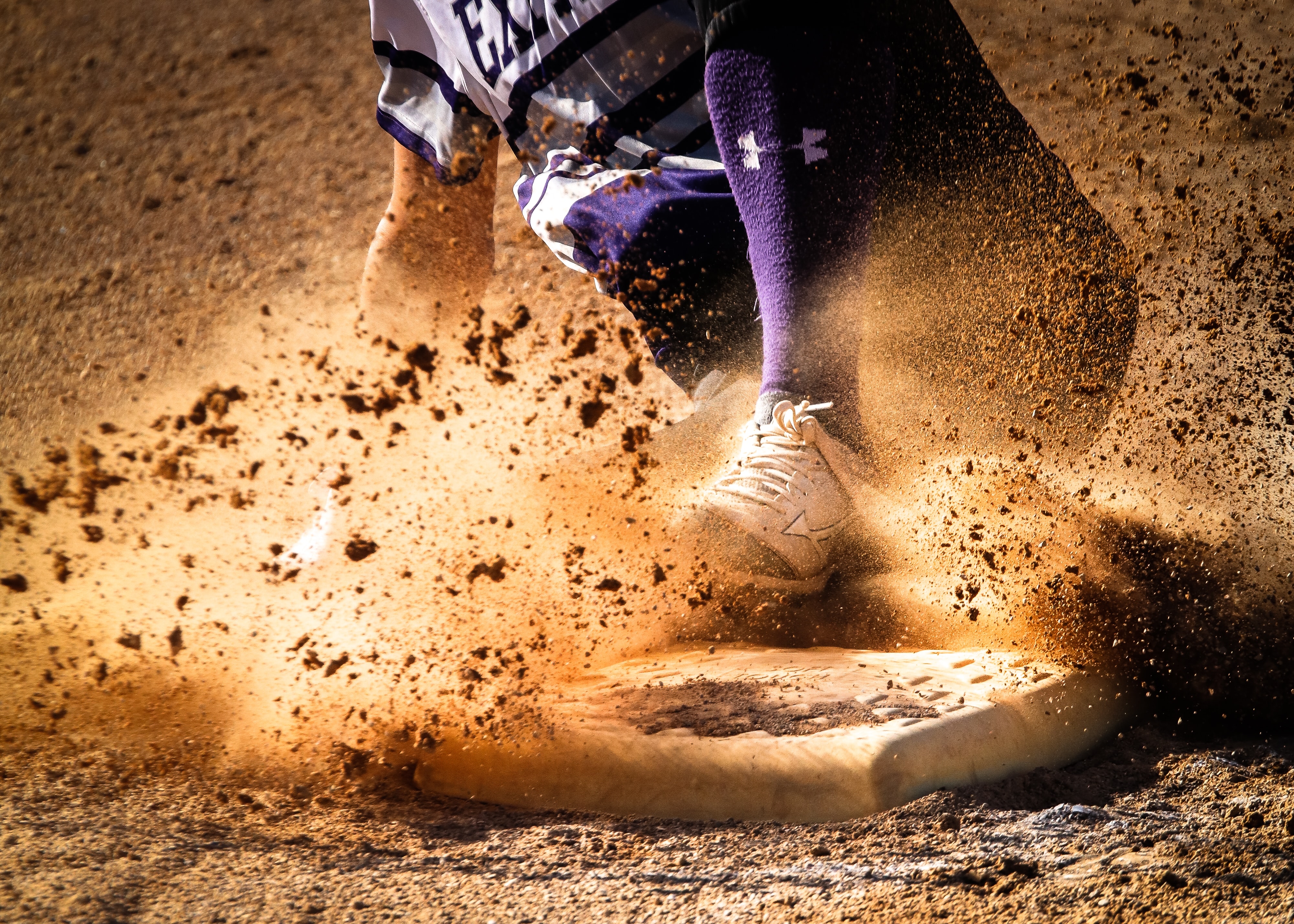 stylized photo of baseball player sliding into base